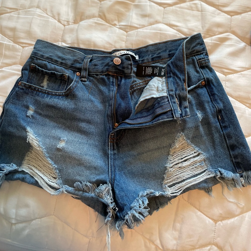 Distressed shorts, worn like twice. Dark blue, not stretchy.